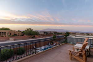 Balcony at dusk featuring a mountain view