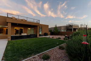 Yard at dusk featuring a balcony