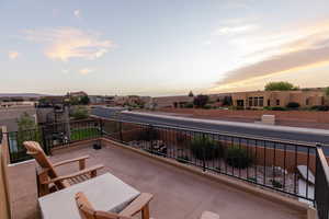 Patio terrace at dusk featuring a balcony