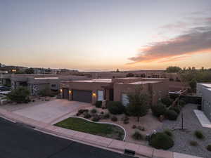 Pueblo-style home featuring a garage