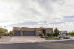 Pueblo-style house with a garage