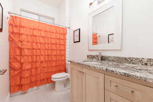 Bathroom with tile patterned flooring, vanity, and toilet