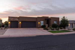 Pueblo revival-style home with a garage