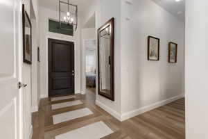 Entrance foyer featuring hardwood / wood-style floors and a chandelier