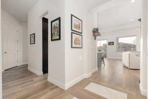 Hallway with light hardwood / wood-style floors