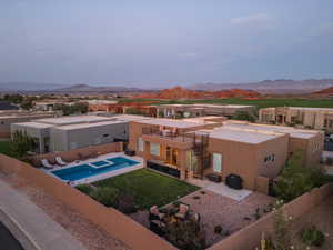 Back of house with a patio area, a mountain view, a balcony, and a fenced in pool