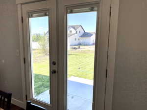 French door off the kitchen to patio into the big backyard.