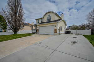 View of front of house featuring a garage and a front yard