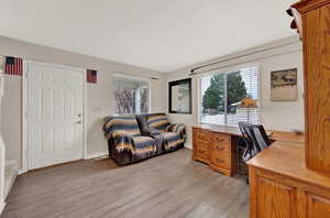 Office space with light hardwood / wood-style floors