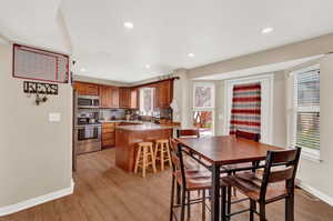 Dining area with light hardwood / wood-style floors and sink