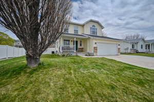 View of front of home with a porch and a front lawn