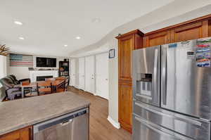 Kitchen featuring appliances with stainless steel finishes and light hardwood / wood-style floors