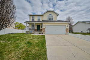 View of front of property with a front yard and a porch