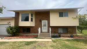 View of front facade with a garage and a front yard