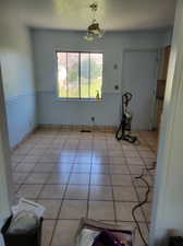 Interior space featuring light tile patterned floors and a chandelier