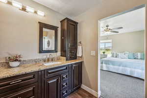 Bathroom with vanity, hardwood / wood-style floors, and ceiling fan