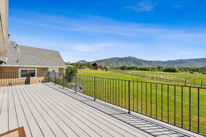 Deck featuring a yard, a rural view, and a mountain view