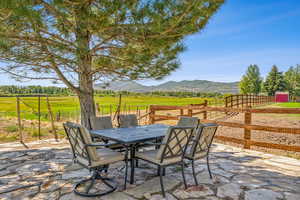 View of patio / terrace featuring a mountain view and a rural view