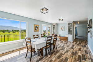 Dining room featuring a mountain view, french doors, and dark hardwood / wood-style flooring