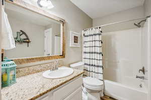 Full bathroom featuring vanity, toilet, and shower / bath combo