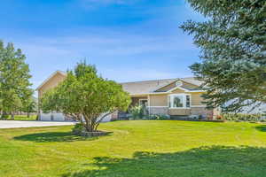 View of front of home with a front yard and a garage