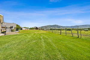 View of yard featuring a mountain view, a rural view, and a patio