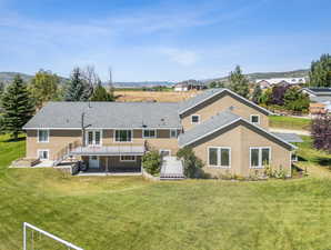 Rear view of property featuring a yard and a patio