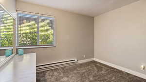 Interior space with carpet flooring and baseboard heating