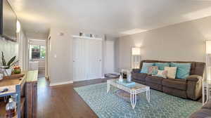 Living room with dark hardwood / wood-style flooring