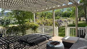 Deck with a pergola and a fire pit