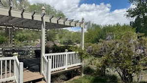 Exterior space with a wooden deck and a pergola