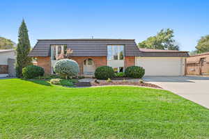 View of front facade with a front yard and a garage