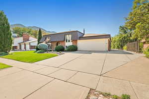 View of front facade featuring a garage, and RV parking