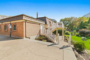 View of home's exterior featuring a yard and a deck with mountain view