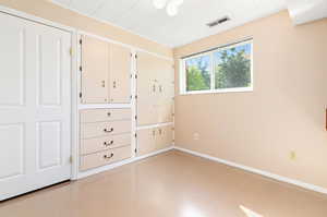 Utility bedroom featuring concrete floors