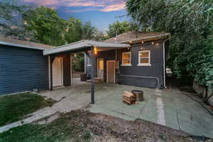 Back house at dusk with a patio