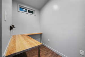 Office space with lofted ceiling and dark hardwood / wood-style flooring