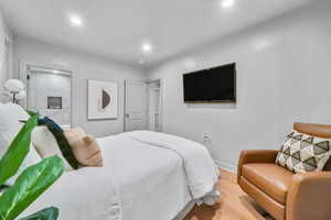 Bedroom with wood-type flooring