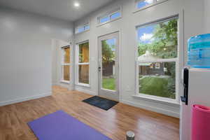 Exercise area featuring light wood-type flooring and a wealth of natural light