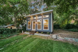 Outdoor structure at dusk with a yard