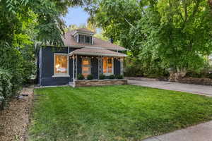 Bungalow-style house featuring covered porch and a front yard