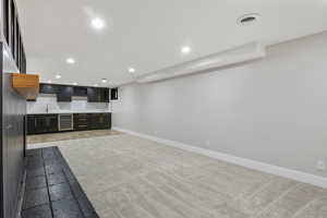 Kitchen featuring light carpet and beverage cooler