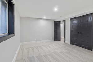 Unfurnished bedroom with light carpet