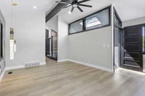 Interior space with a wealth of natural light, light hardwood / wood-style flooring, and ceiling fan