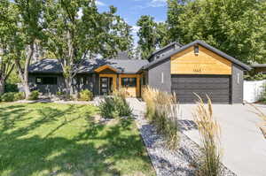 View of front of home with a garage and a front yard