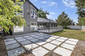 Back of house with a yard and a patio area