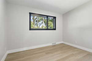 Spare room with light hardwood / wood-style flooring