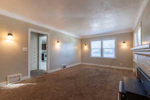 Unfurnished living room featuring a fireplace and carpet flooring