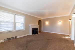 Unfurnished living room featuring carpet