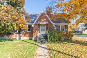 Tudor home with a front yard